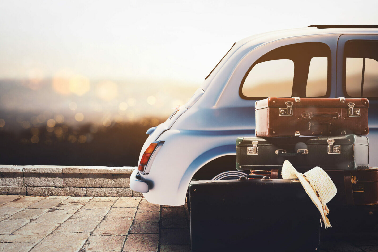 Car on the road ready for summer holiday during sunset with luggage